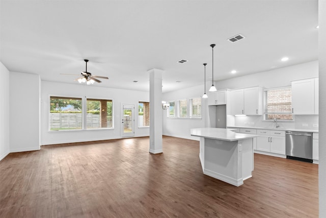 kitchen featuring ceiling fan, dishwasher, a center island, hanging light fixtures, and white cabinets