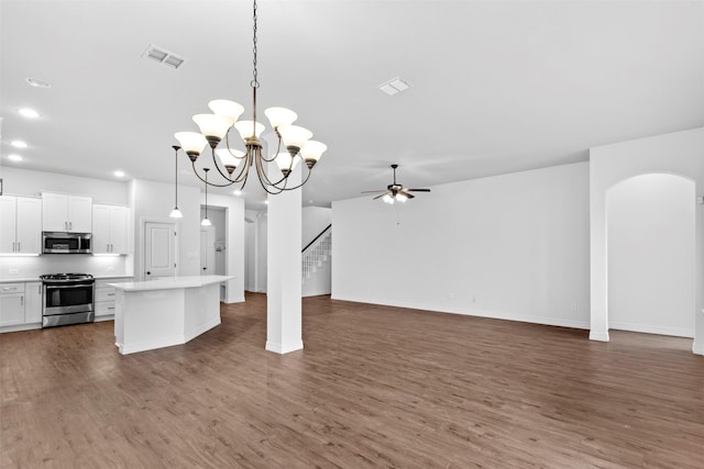 kitchen featuring a kitchen island, pendant lighting, white cabinetry, appliances with stainless steel finishes, and ceiling fan with notable chandelier