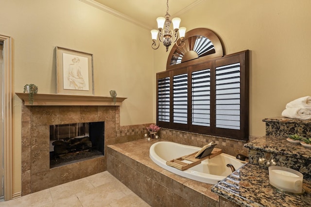 bathroom with tiled tub, a notable chandelier, crown molding, and a tiled fireplace