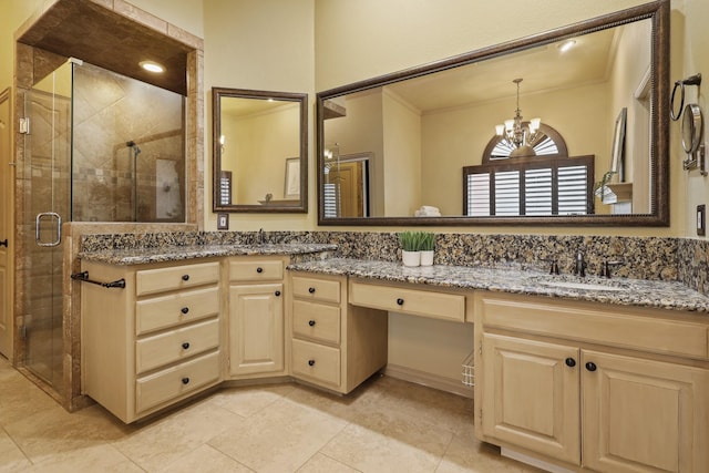 bathroom featuring vanity, a shower with door, and a chandelier