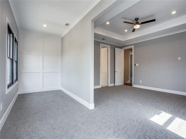 carpeted empty room with ceiling fan and ornamental molding