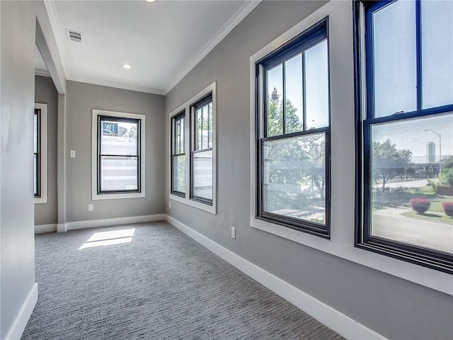 unfurnished room with crown molding and carpet flooring