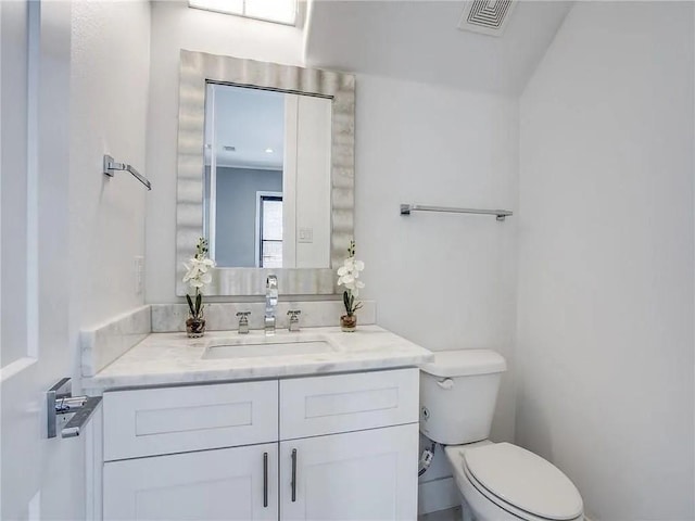 bathroom with toilet and vanity