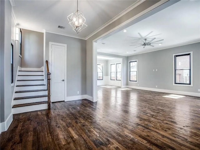 unfurnished living room with crown molding, dark wood-type flooring, and ceiling fan with notable chandelier