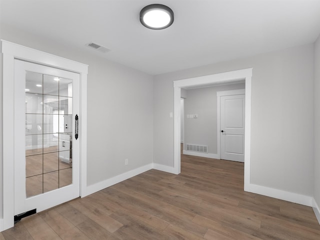 spare room with hardwood / wood-style flooring