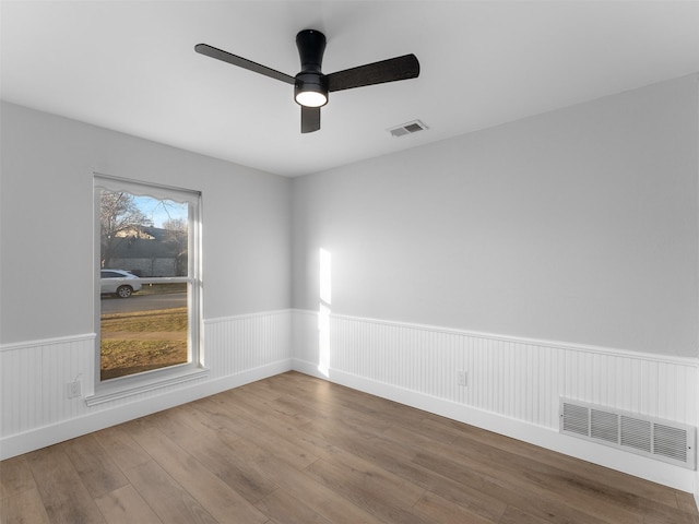 spare room featuring ceiling fan and hardwood / wood-style floors