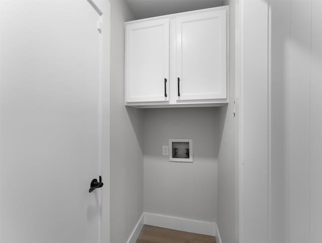 laundry area with washer hookup, cabinets, and wood-type flooring