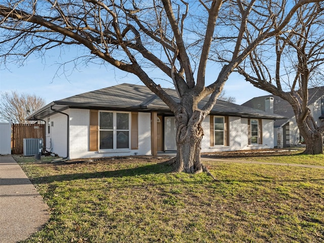 ranch-style home with a front lawn and central AC