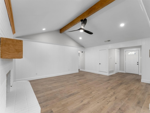 unfurnished living room featuring a brick fireplace, light hardwood / wood-style floors, lofted ceiling with beams, and ceiling fan