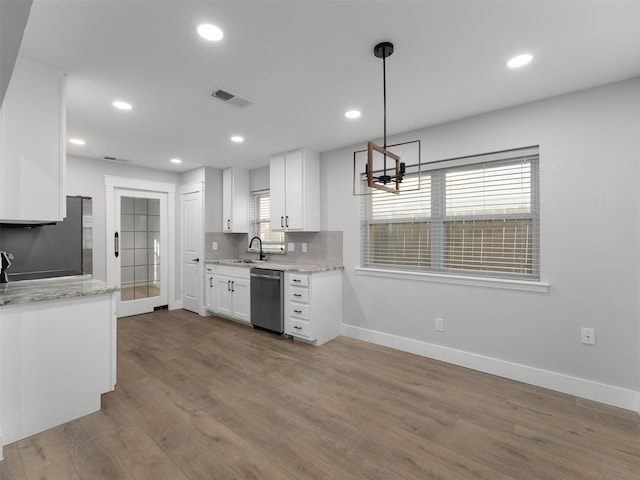 kitchen featuring white cabinetry, appliances with stainless steel finishes, backsplash, light wood-type flooring, and hanging light fixtures