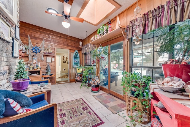 sunroom / solarium featuring ceiling fan