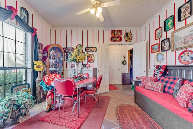 dining space with ceiling fan and a textured ceiling