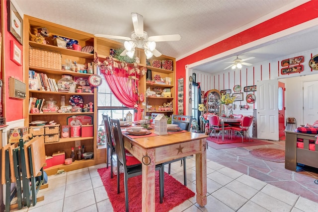 tiled dining area featuring ceiling fan and a textured ceiling