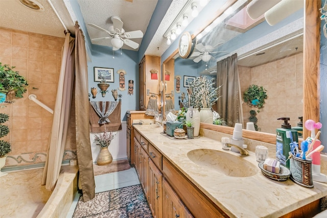 bathroom featuring ceiling fan, tile patterned floors, vanity, and a textured ceiling