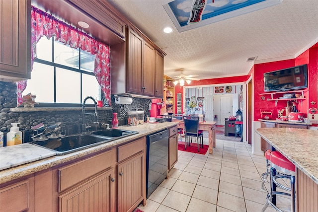 kitchen featuring sink, a textured ceiling, light tile patterned floors, black dishwasher, and ceiling fan