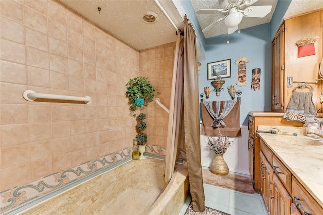 bathroom with vanity, tile patterned floors, shower / bath combination with curtain, and a textured ceiling