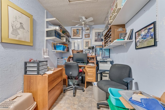 office with ceiling fan and a textured ceiling