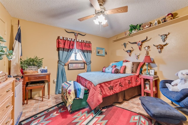 bedroom with ceiling fan and a textured ceiling