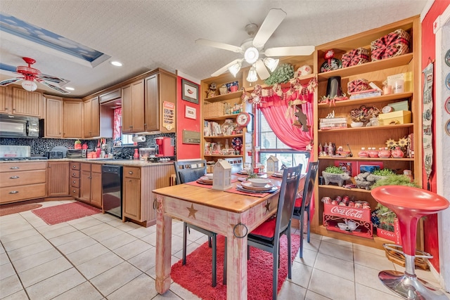 kitchen with decorative backsplash, light tile patterned floors, ceiling fan, black appliances, and a textured ceiling