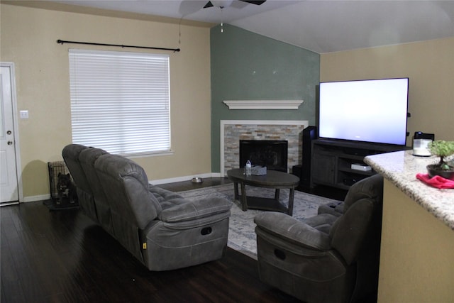 living room with ceiling fan, dark hardwood / wood-style floors, and a fireplace