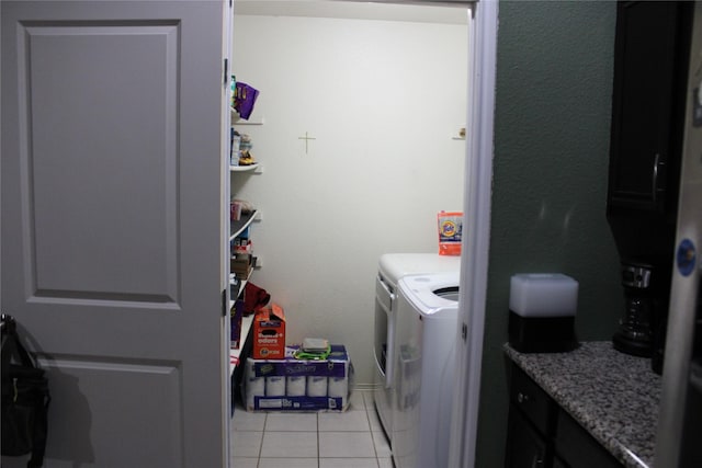 washroom featuring separate washer and dryer and light tile patterned floors