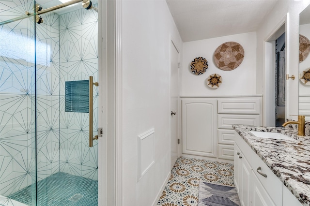 bathroom with vanity, a shower with door, and tile patterned floors