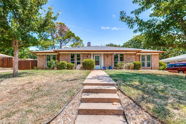 single story home featuring a front lawn