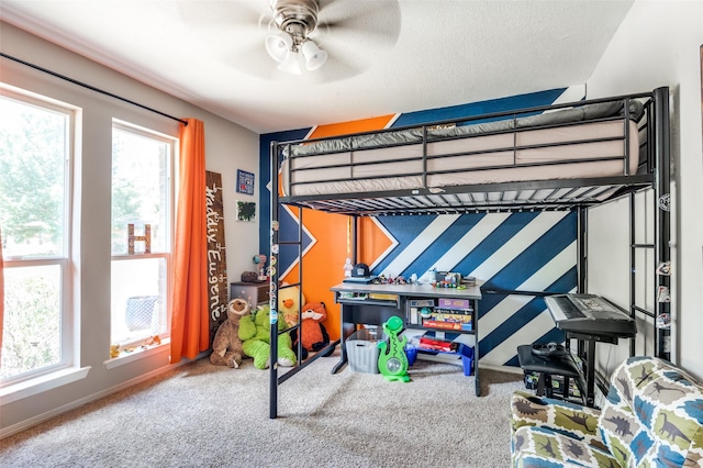 bedroom with a textured ceiling, ceiling fan, and carpet