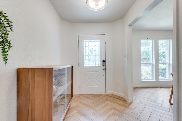 entryway with a wealth of natural light and light parquet flooring