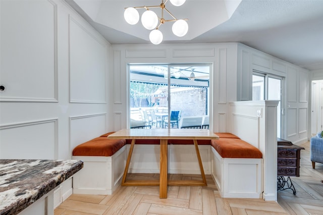 dining room featuring plenty of natural light, a chandelier, and breakfast area