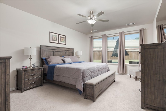 bedroom with ceiling fan and light carpet