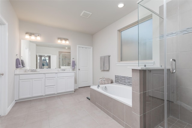 bathroom with tile patterned floors, vanity, and plus walk in shower