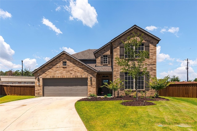 view of front of home with a garage and a front yard