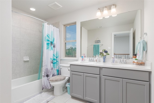 full bathroom featuring toilet, vanity, tile patterned flooring, and shower / tub combo