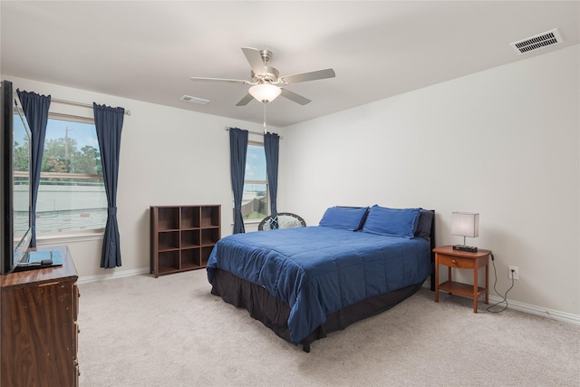 bedroom with ceiling fan and light colored carpet