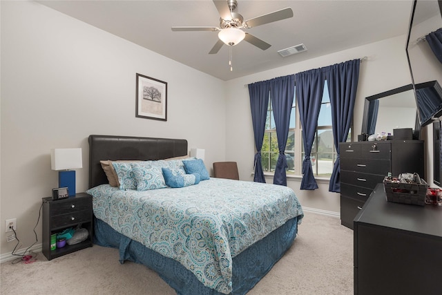 bedroom with ceiling fan and light carpet