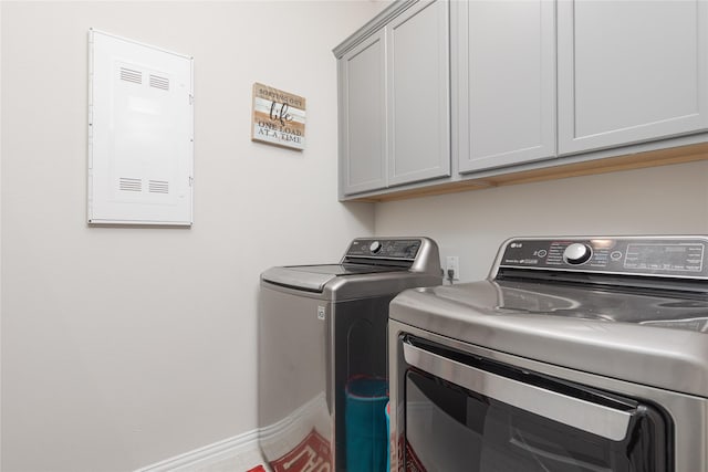 washroom with washing machine and dryer and cabinets