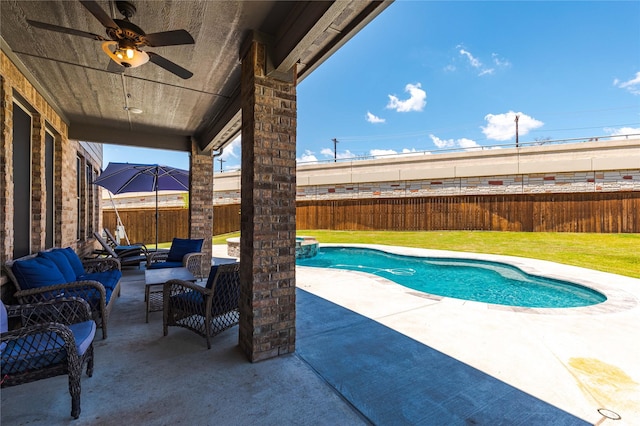 view of swimming pool with ceiling fan, an outdoor hangout area, a lawn, and a patio area