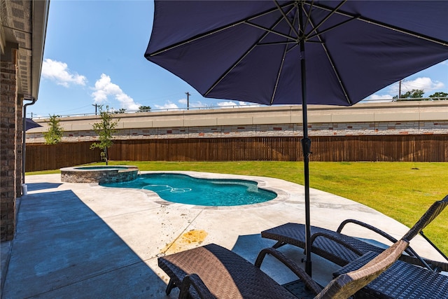 view of pool with a patio area, an in ground hot tub, and a lawn