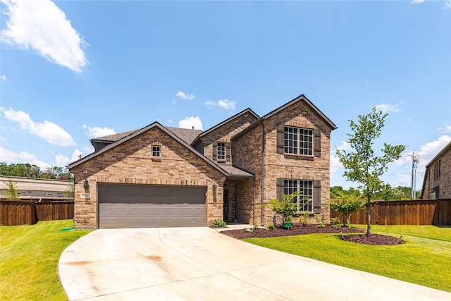 view of front of house featuring a front lawn and a garage