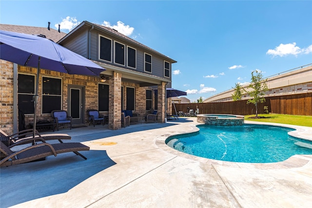 view of pool with an in ground hot tub and a patio