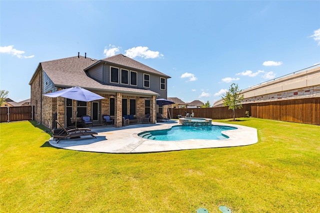 back of house with a swimming pool with hot tub, a yard, and a patio