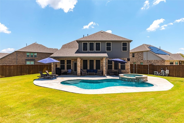 view of pool with a yard, a pool with connected hot tub, outdoor lounge area, a patio area, and a fenced backyard