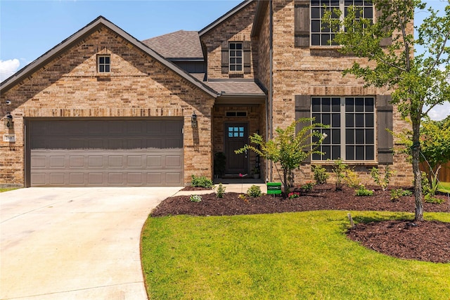 view of front of house with a front yard and a garage