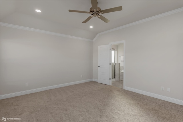 carpeted empty room featuring vaulted ceiling, ceiling fan, and ornamental molding