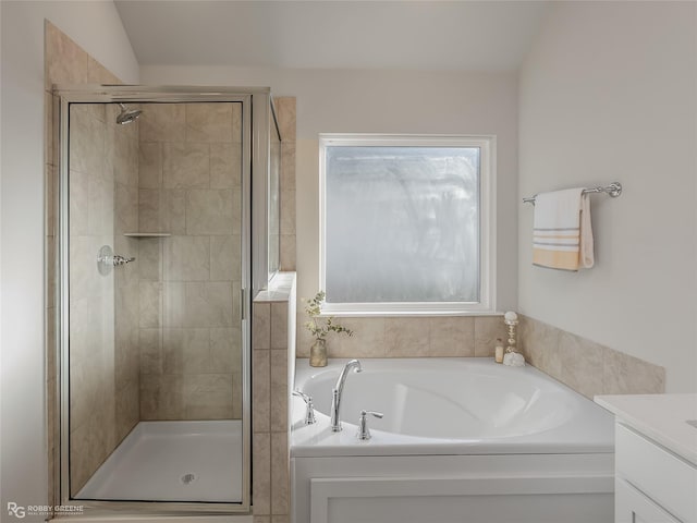 bathroom featuring vanity, vaulted ceiling, and independent shower and bath