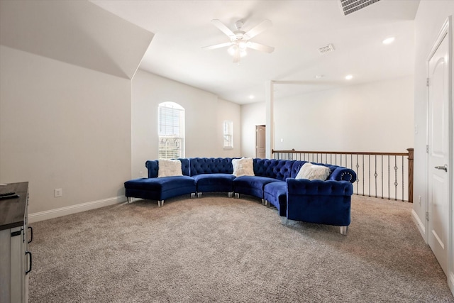 carpeted living room with ceiling fan