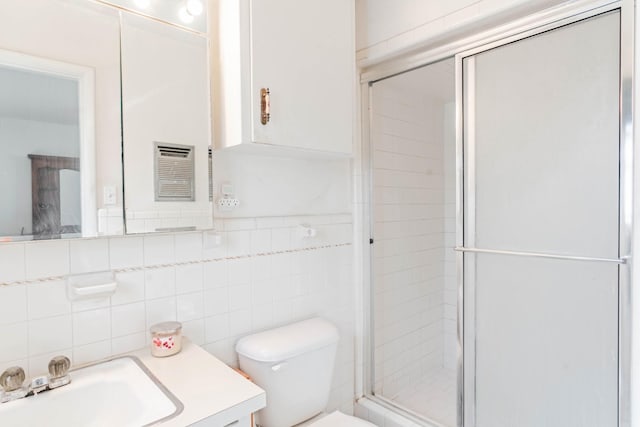 bathroom with toilet, tile walls, walk in shower, and vanity