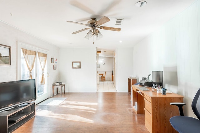 office with ceiling fan and light hardwood / wood-style floors