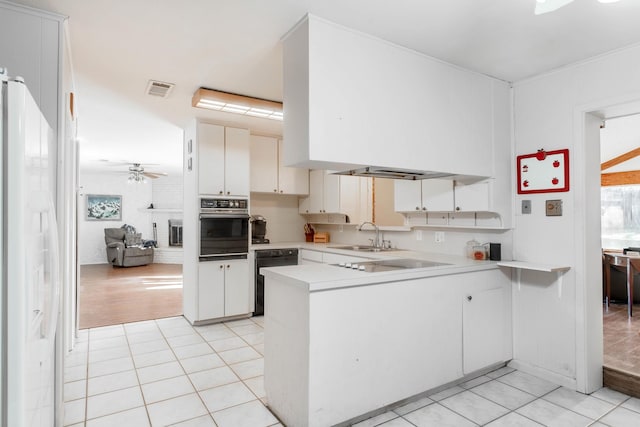 kitchen with white cabinetry, kitchen peninsula, and black appliances